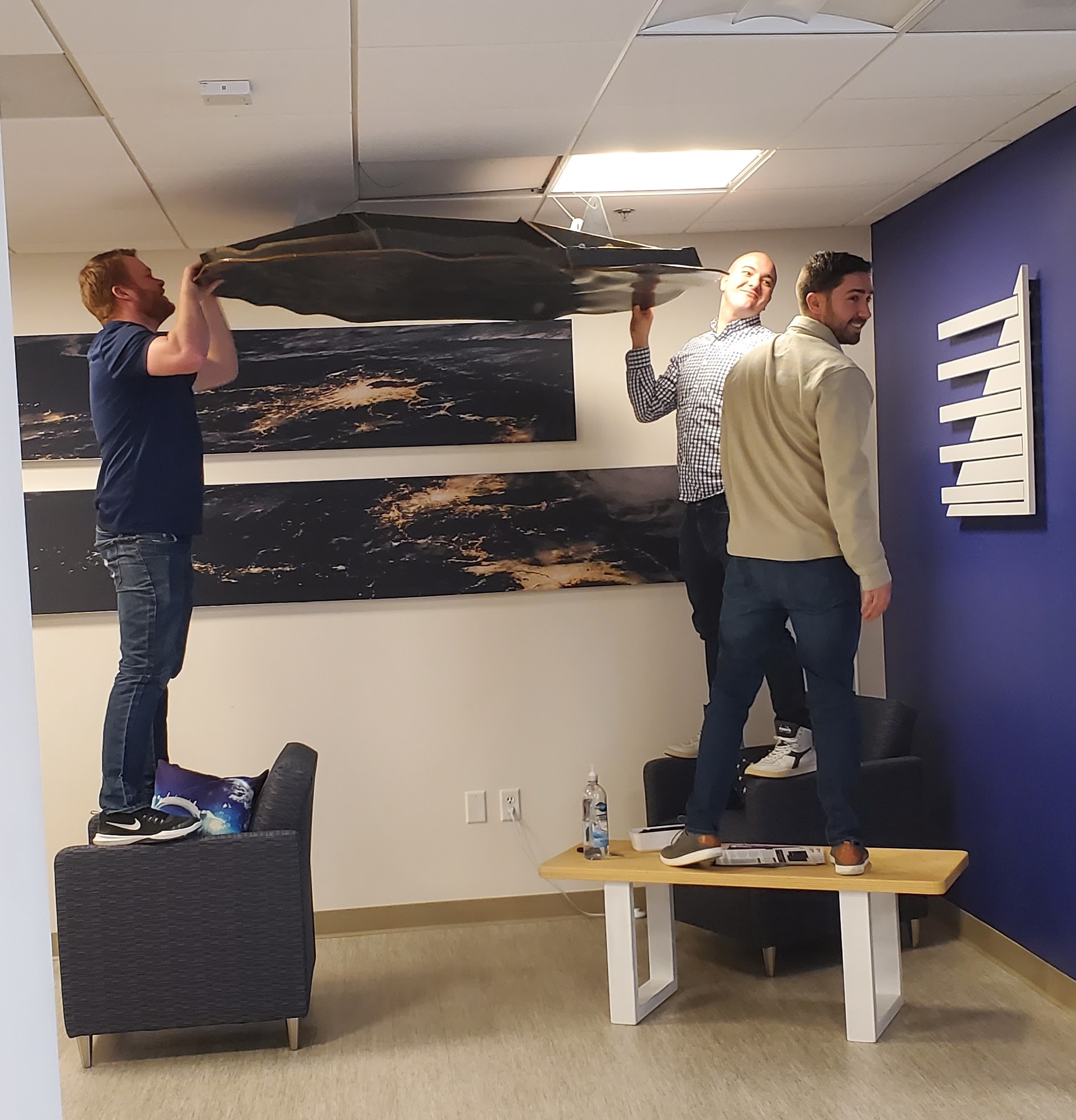 Sedarians hanging mission art in the lounge
